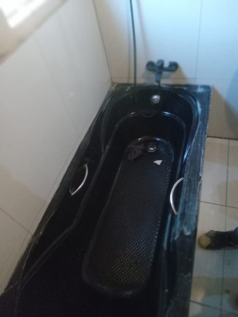 Black bathtub plumbed and installed in the same bathroom project